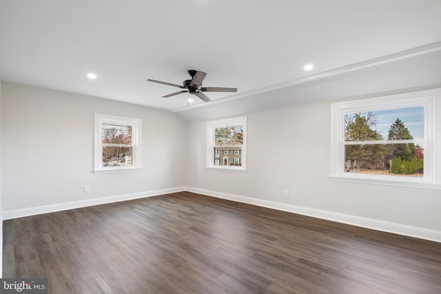 unfurnished room featuring dark hardwood / wood-style flooring, plenty of natural light, and ceiling fan