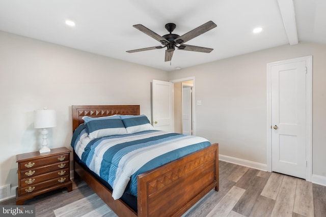 bedroom featuring lofted ceiling with beams, ceiling fan, and wood-type flooring