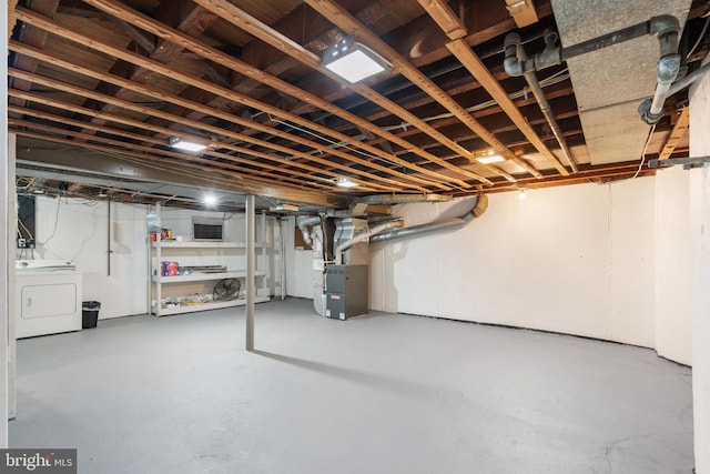 basement with washer / clothes dryer and heating unit