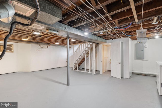 basement featuring electric panel and washer / clothes dryer