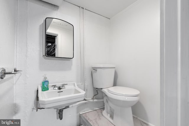 bathroom with toilet and crown molding