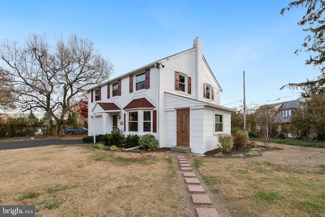 view of front of house featuring a garage and a front lawn