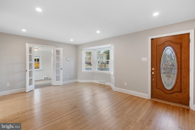 foyer featuring french doors and light wood-type flooring