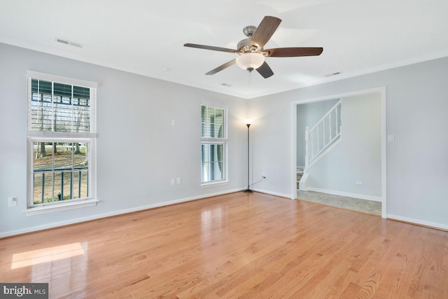 spare room featuring crown molding, ceiling fan, and light hardwood / wood-style floors