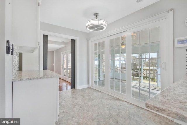 interior space with ceiling fan