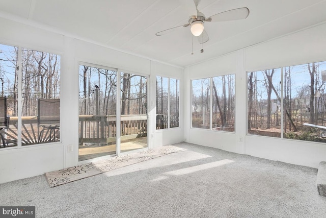 unfurnished sunroom with ceiling fan