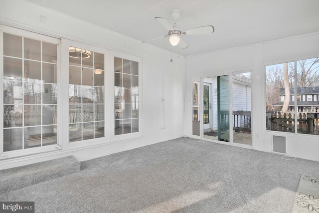 unfurnished sunroom featuring ceiling fan