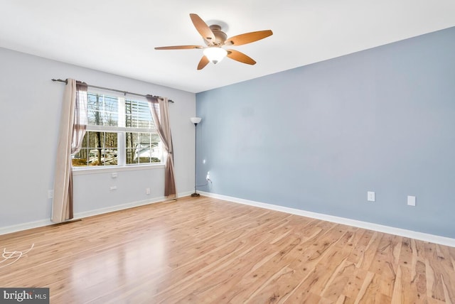 empty room featuring ceiling fan and light wood-type flooring