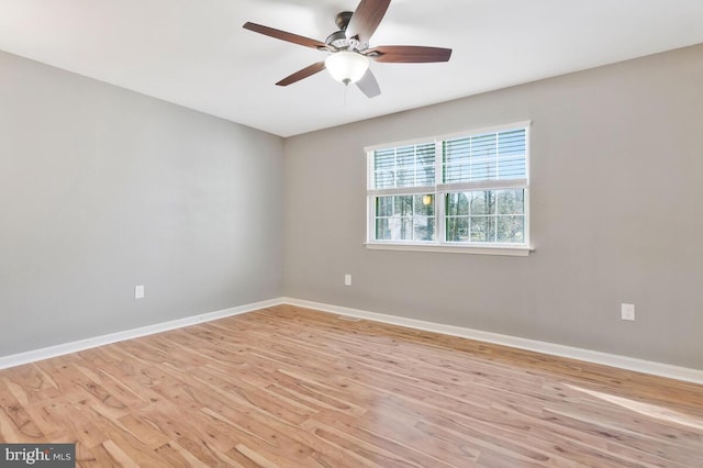 spare room with ceiling fan and light wood-type flooring