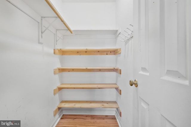 spacious closet with light hardwood / wood-style floors