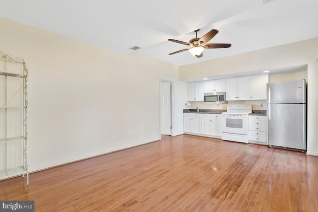 kitchen featuring sink, white cabinets, ceiling fan, stainless steel appliances, and light wood-type flooring