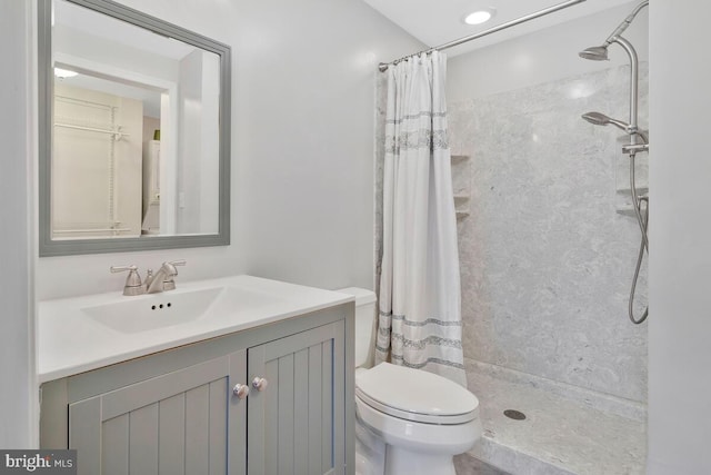 bathroom featuring vanity, curtained shower, and toilet