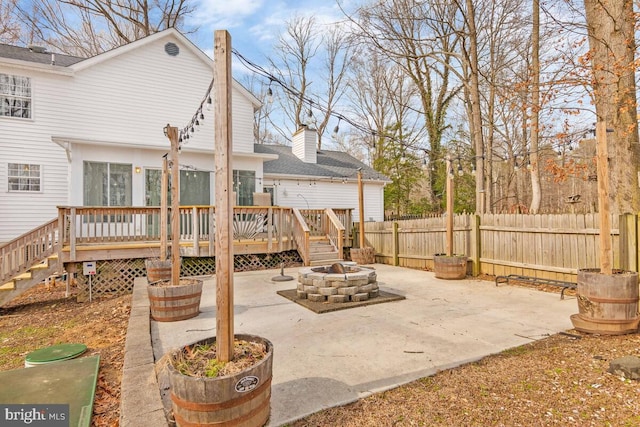 view of patio / terrace with a wooden deck and a fire pit