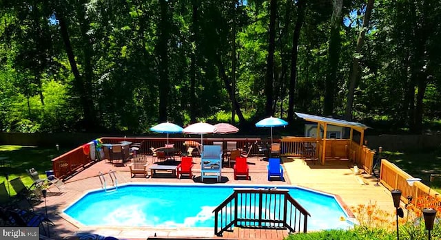 view of pool with a wooden deck