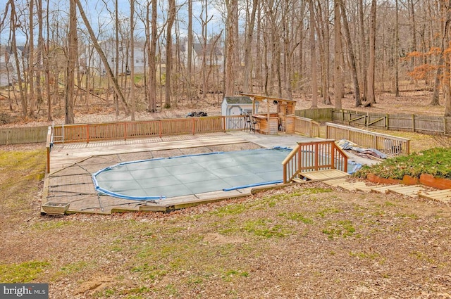 view of pool with a storage shed