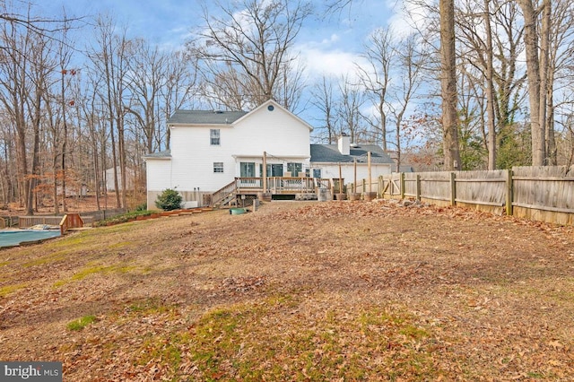 back of house featuring a deck