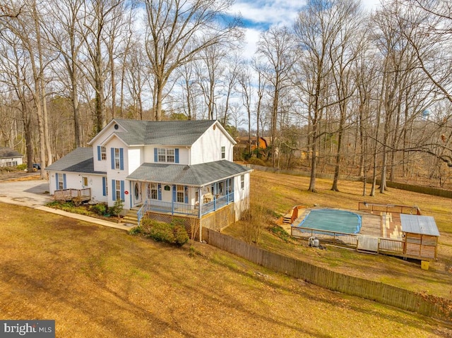 view of front of property featuring a deck and a front lawn