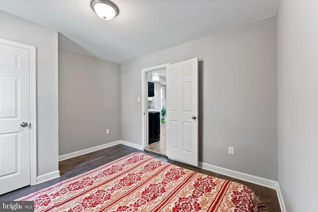 bedroom with dark hardwood / wood-style floors