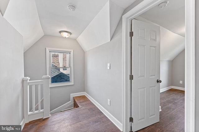 additional living space with dark hardwood / wood-style floors and vaulted ceiling