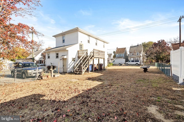 back of house with a deck