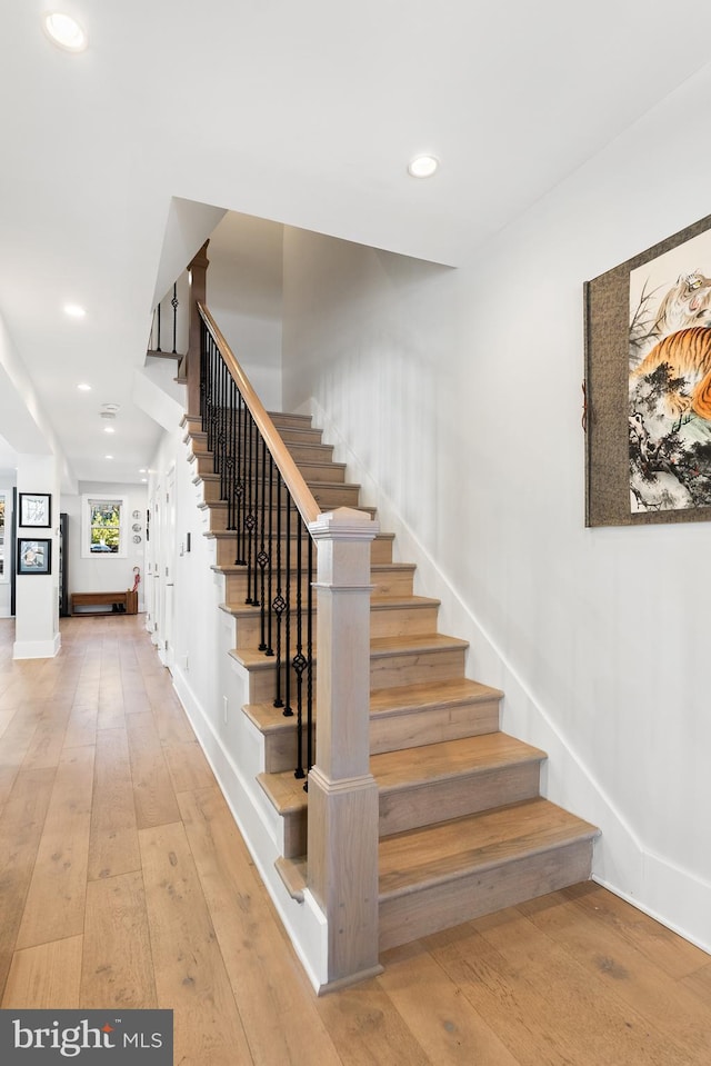 stairway featuring hardwood / wood-style flooring