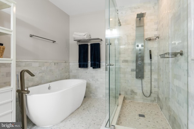 bathroom with separate shower and tub and tile walls