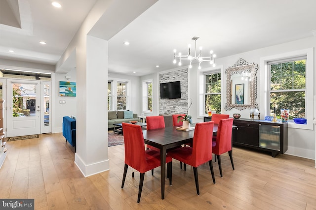 dining area featuring light hardwood / wood-style flooring and an inviting chandelier