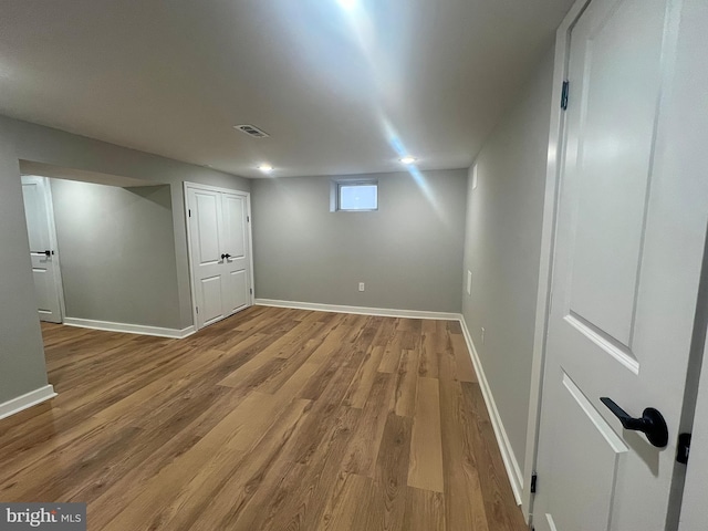 basement with hardwood / wood-style flooring