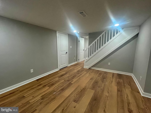 basement with hardwood / wood-style floors