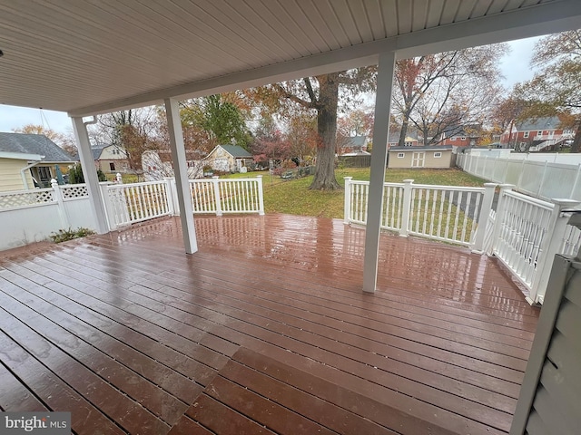 wooden terrace featuring a yard