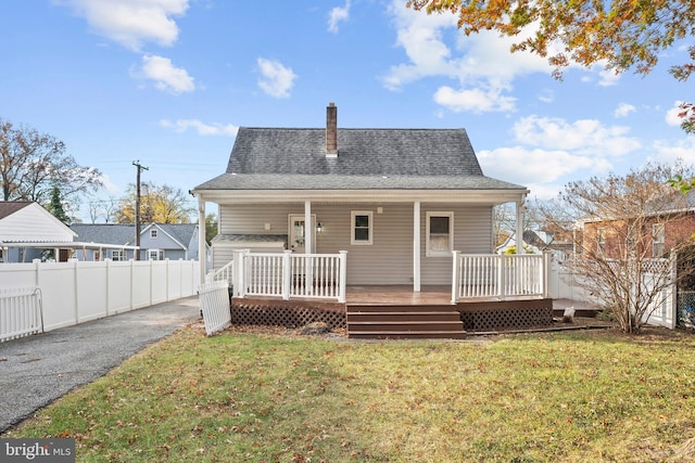 back of property featuring a yard