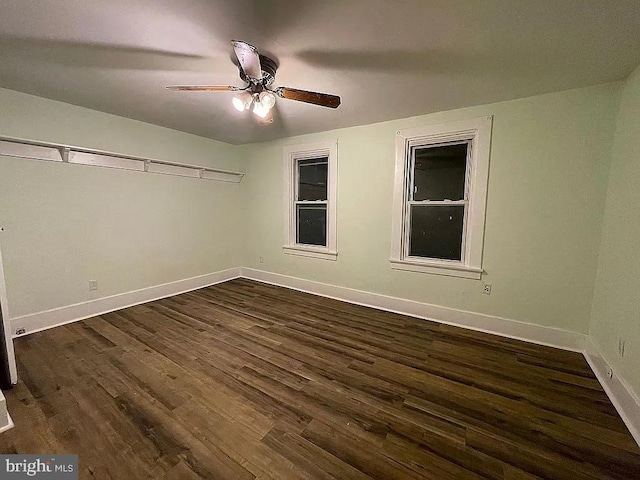 unfurnished room with ceiling fan and dark wood-type flooring