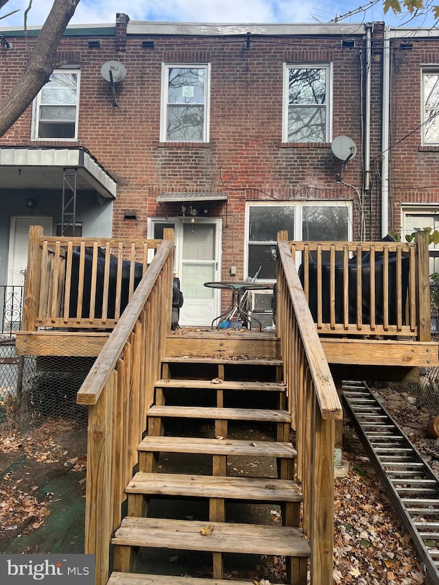 back of property with a wooden deck