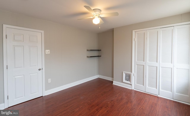 unfurnished bedroom featuring a closet, dark hardwood / wood-style floors, and ceiling fan