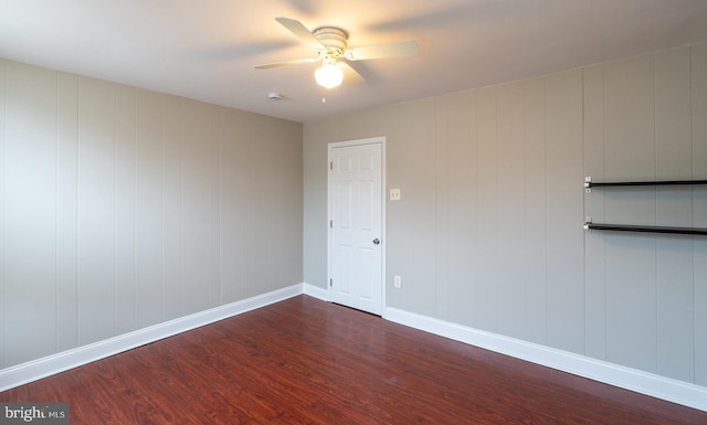 unfurnished room featuring dark hardwood / wood-style floors and ceiling fan