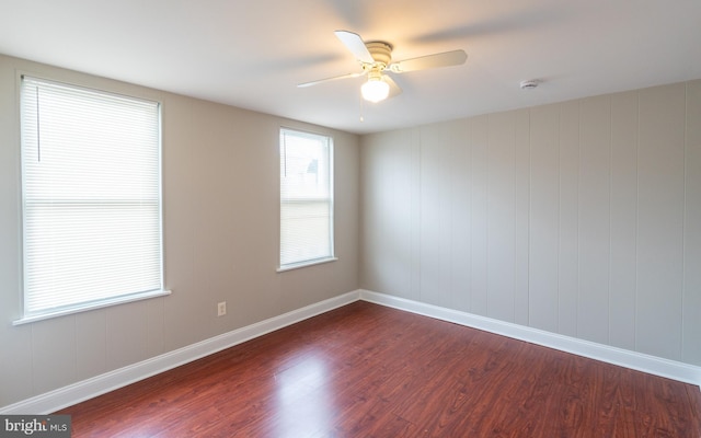 spare room featuring ceiling fan and dark wood-type flooring