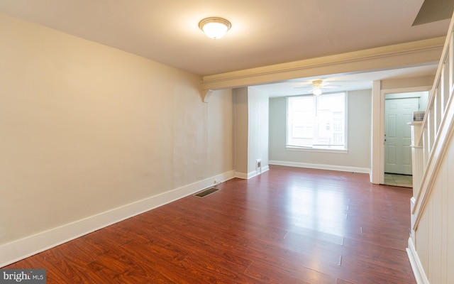 unfurnished room with ceiling fan and dark wood-type flooring