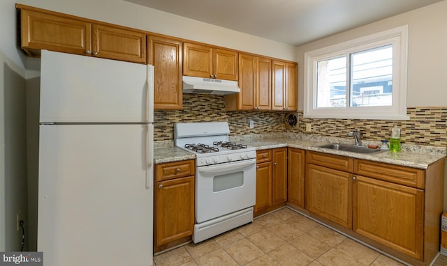 kitchen with decorative backsplash, white appliances, sink, and light tile patterned floors