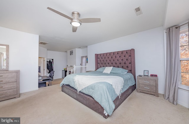 bedroom featuring ceiling fan and light colored carpet