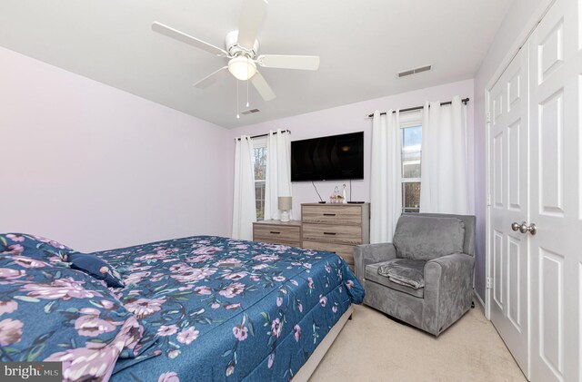 bedroom featuring ceiling fan, a closet, and carpet