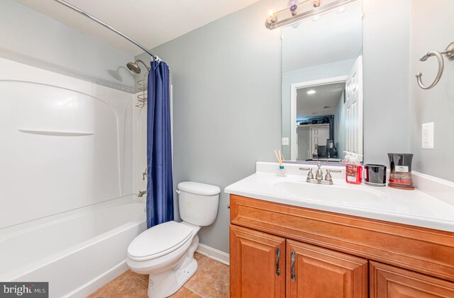 full bathroom featuring tile patterned flooring, vanity, toilet, and shower / bath combo with shower curtain