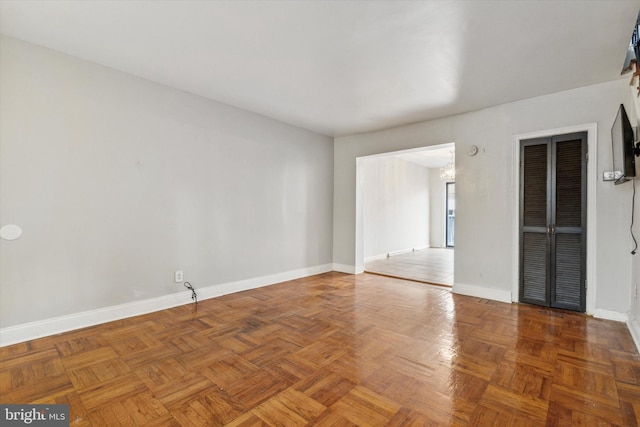 unfurnished room with parquet flooring