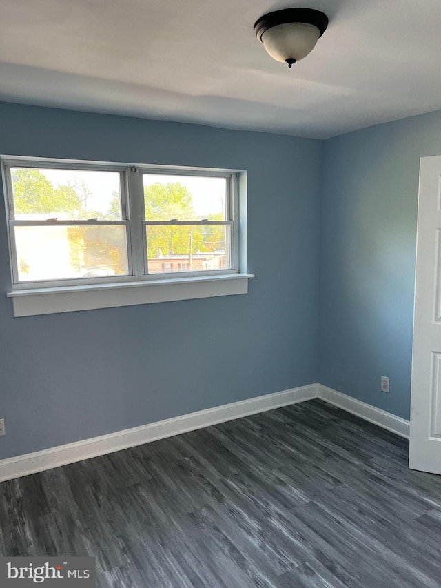 spare room with dark hardwood / wood-style floors