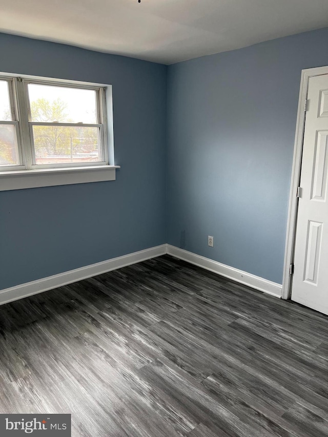 empty room featuring dark wood-type flooring