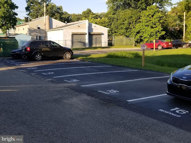 view of vehicle parking with a lawn