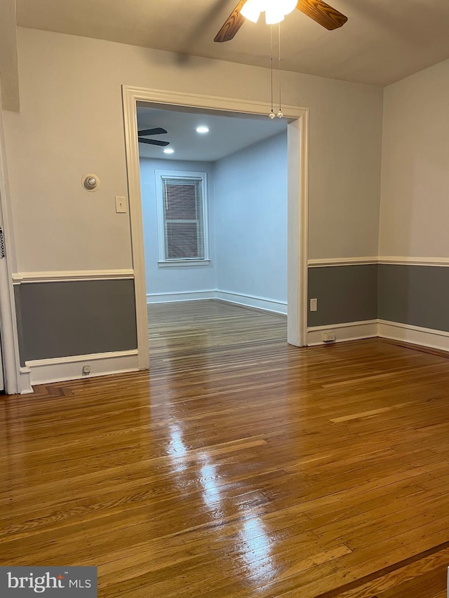 empty room featuring ceiling fan and wood-type flooring