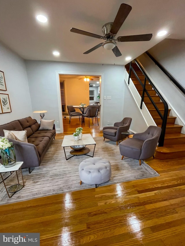 living room with hardwood / wood-style floors and ceiling fan