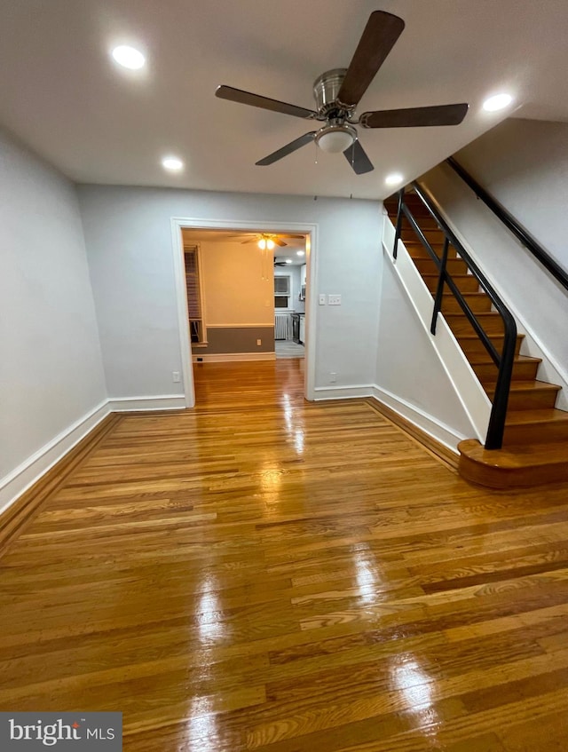 unfurnished living room featuring wood-type flooring and ceiling fan