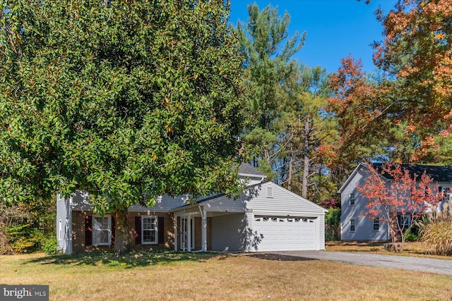 view of front of house with a garage and a front yard