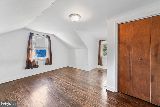 bonus room with dark hardwood / wood-style floors and lofted ceiling